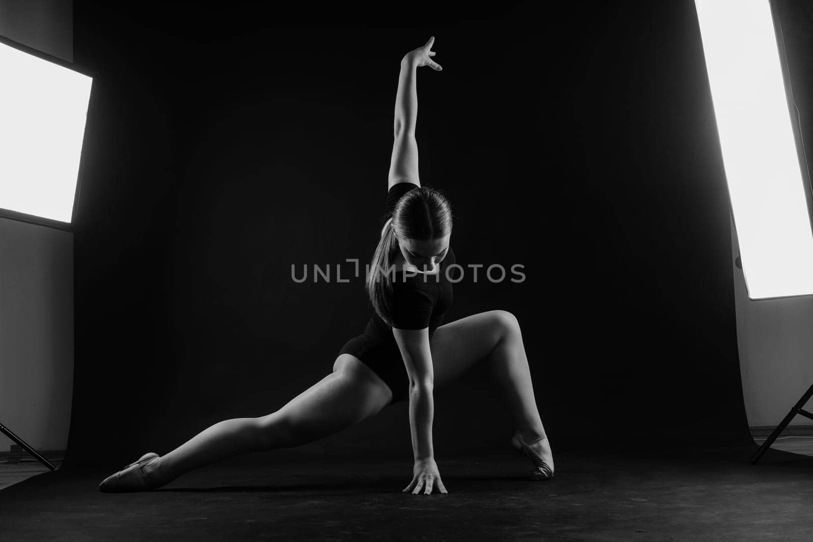 Fashion girl ballet dancer. Sport gymnastics studio shot on a white and black background