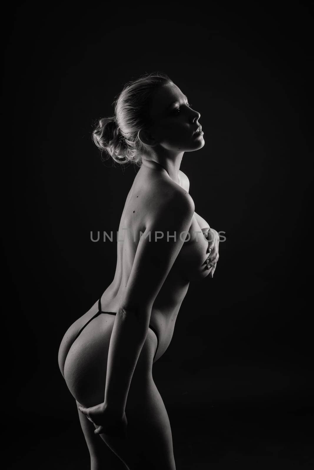 Happy plump body positive blond haired lady poses topless