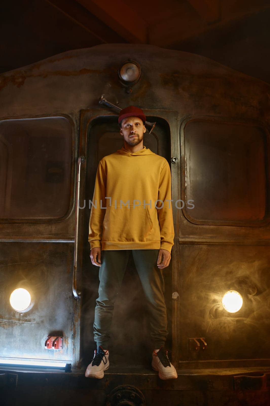 Breakdancer hipster b-boy standing at urban subway train. Contemporary freestyle dance performance concept