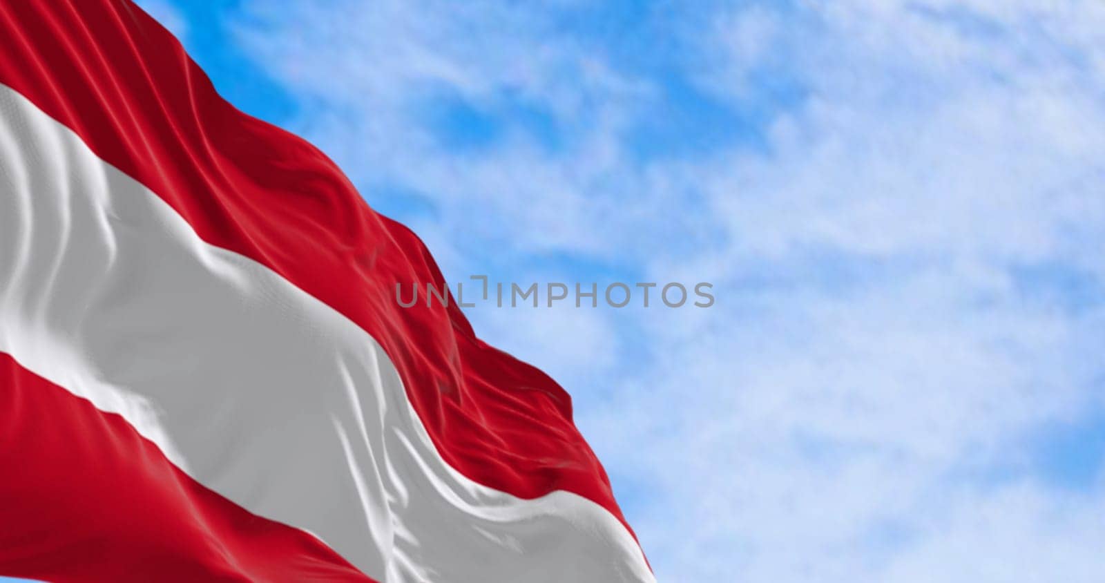The national flag of Austria waving on a clear day. Three equal horizontal bands: white, red upper & lower, middle band. 3d illustration render. Selective focus. Rippled fabric.