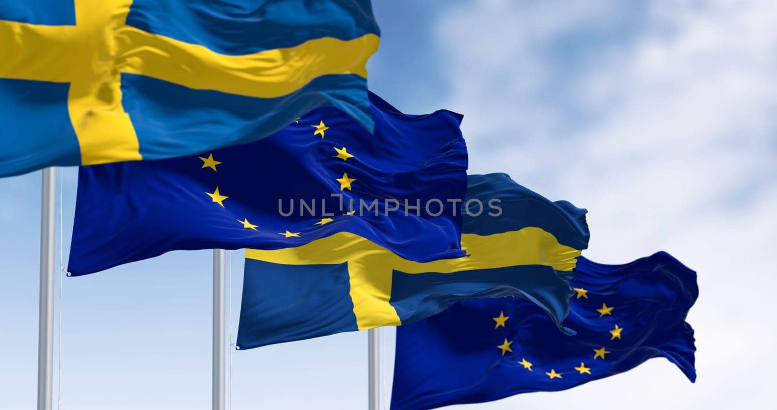 The flags of Sweden and the European Union waving together on a clear day. Sweden became a member of the European Union on January 1, 1995. 3d illustration render. Selective focus. Rippled fabric
