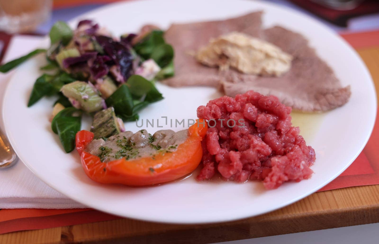 A delicious starter from Piedmont. Steak tartare, carpaccio, stuffed peppers, and salad