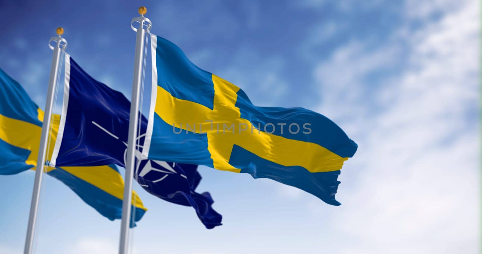 Brussels, BL, July 10 2023: The flags of Sweden and NATO waving in the wind. Sweden and NATO have a close relationship. Illustrative editorial 3d illustration render