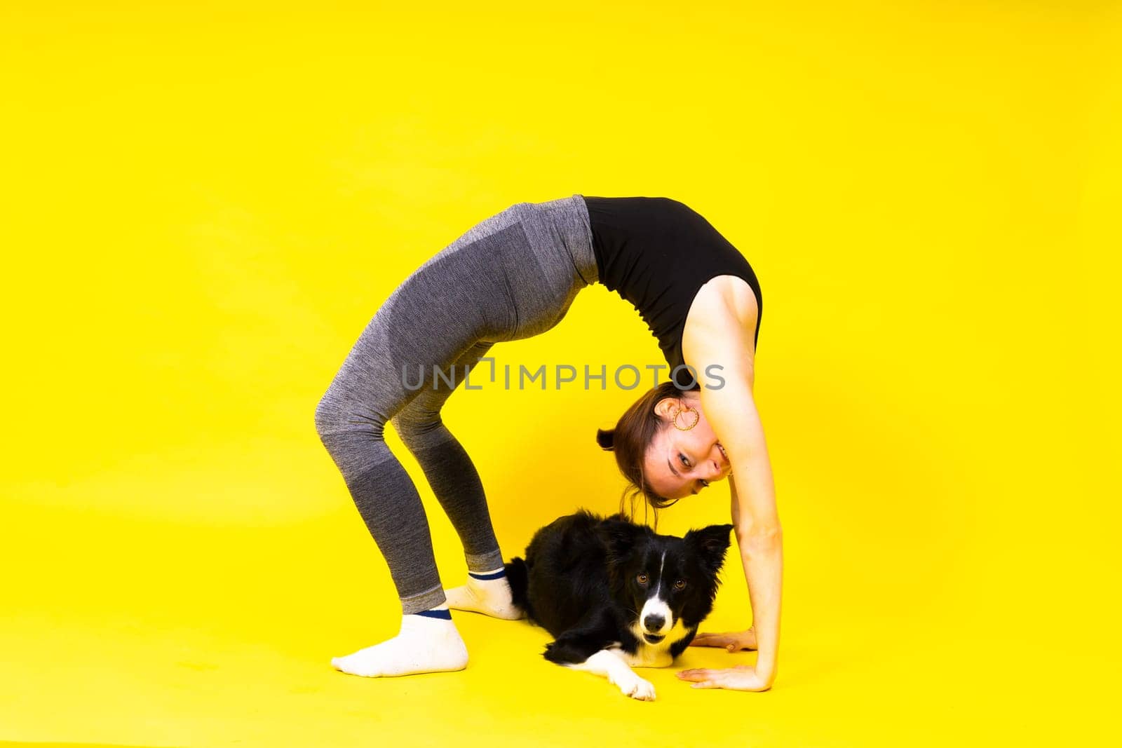Woman walks and getting exercise for both herself and her border collie dog.