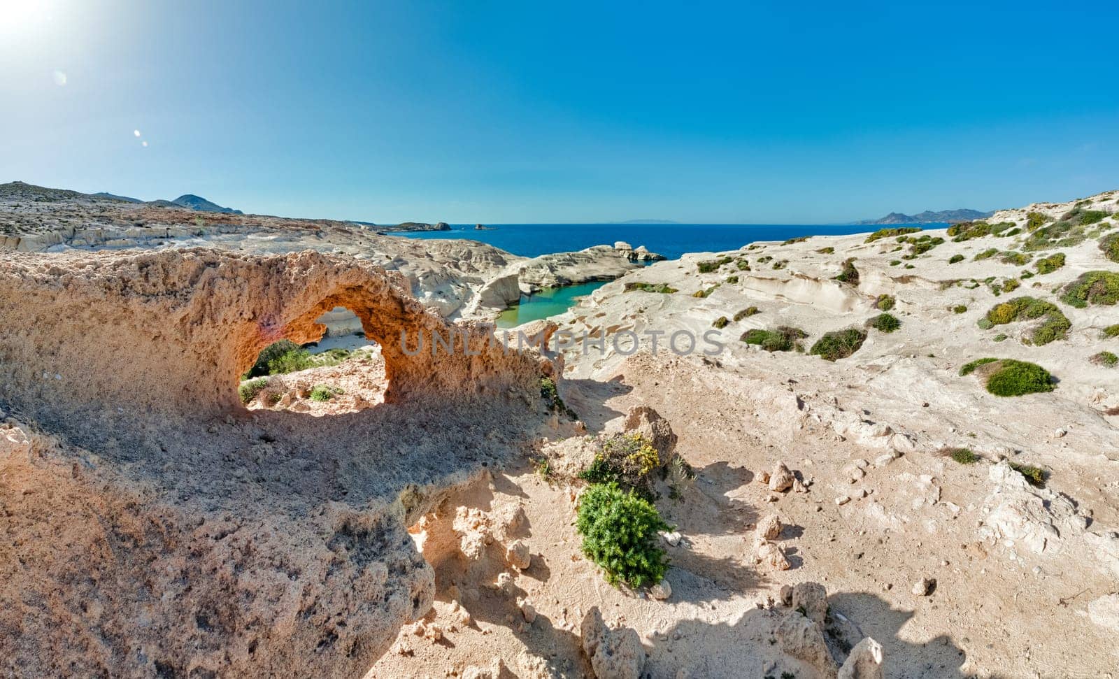 Beautiful landscape of famous white rocks, Sarakiniko beach, Aegean sea, Milos island , Greece. No people, empty cliffs, summer day sunshine, clear sea, blue waters, azure lagoon, fantastic rocks of tourist destination.