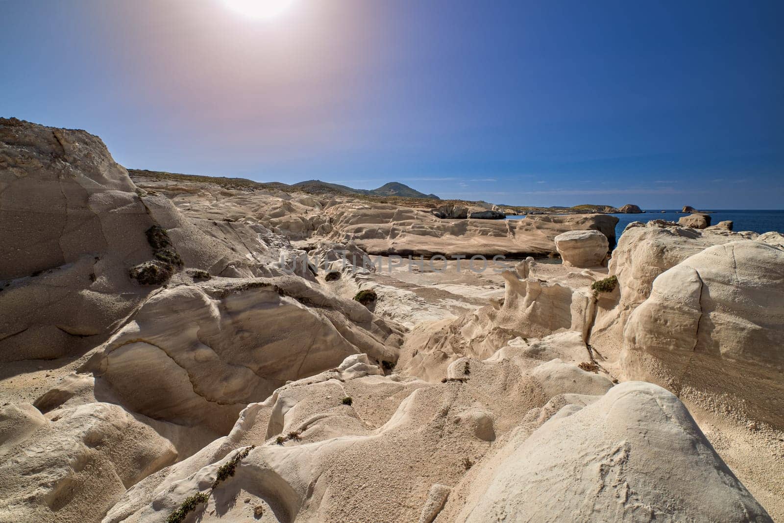 Famous white rocks of Sarakiniko beach, Aegean sea, Milos island , Greece. No people, empty cliffs, summer day sunshine, clear blue sky, beautiful landscape, fantastic rocks of tourist destination.