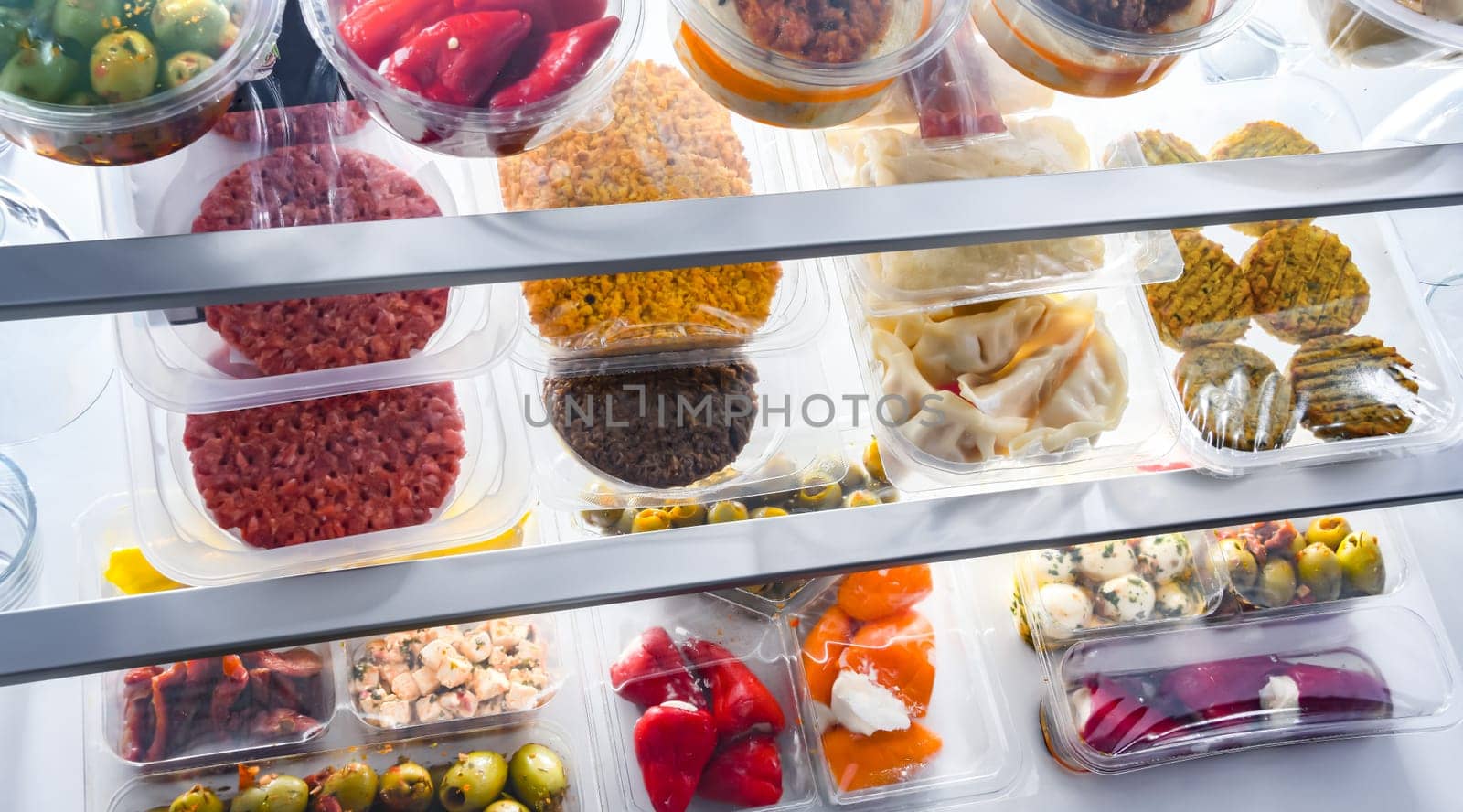A display of variety of prepackaged food products in plastic boxes.