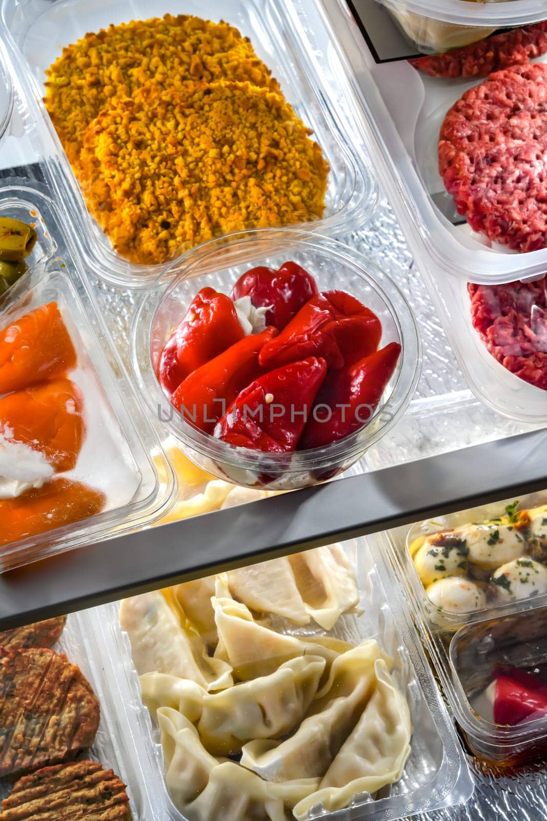 A display of variety of prepackaged food products in plastic boxes.