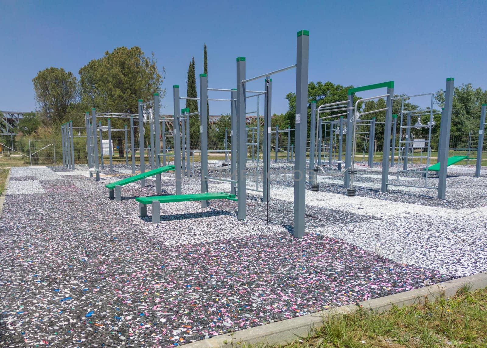 Calisthenics park floor made from recycled rubber particles. Outdoors daylight shot