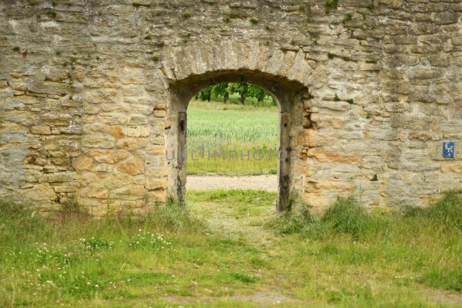 Fields and meadows through a historic wall