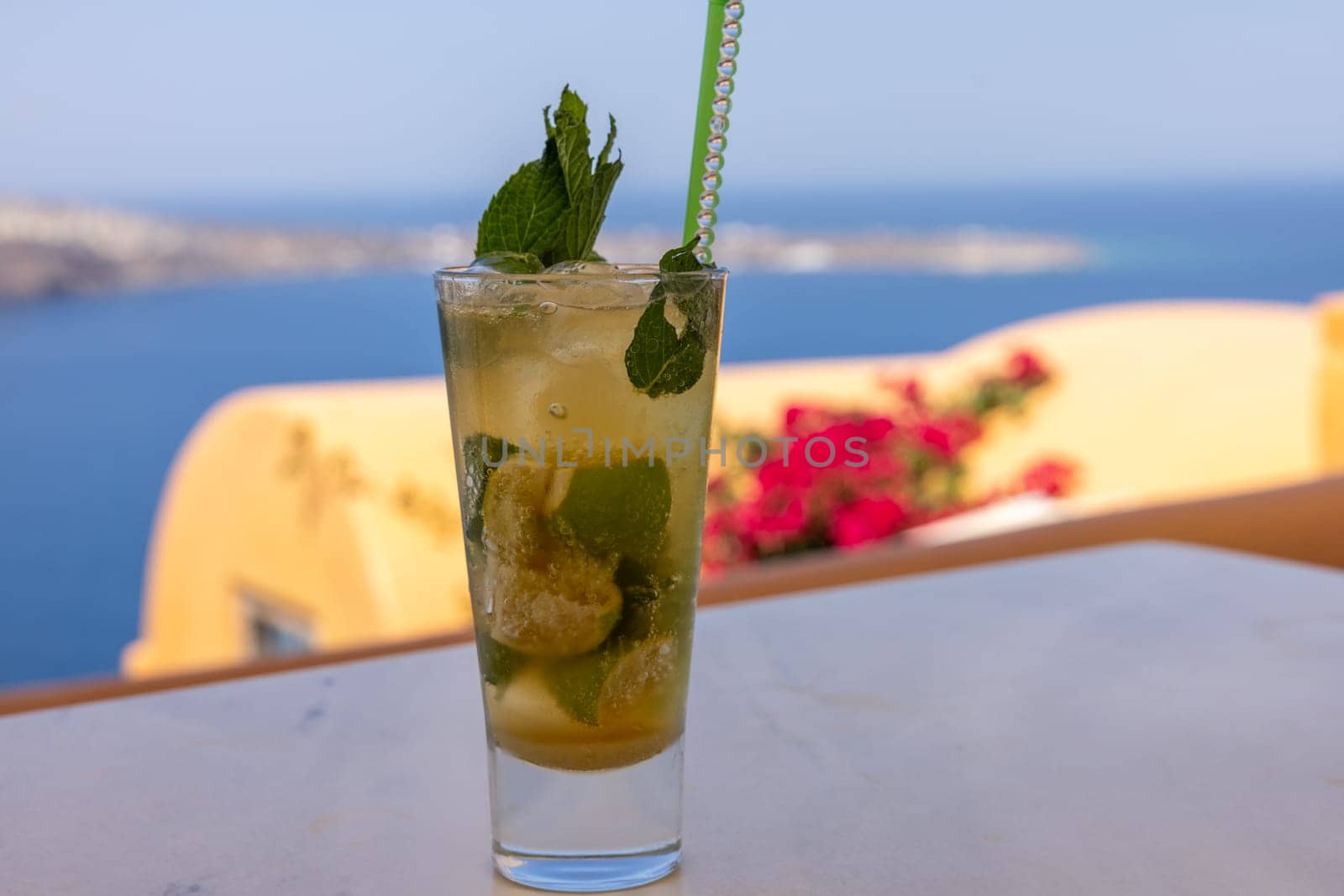 Mojito cocktail in a glass with a straw