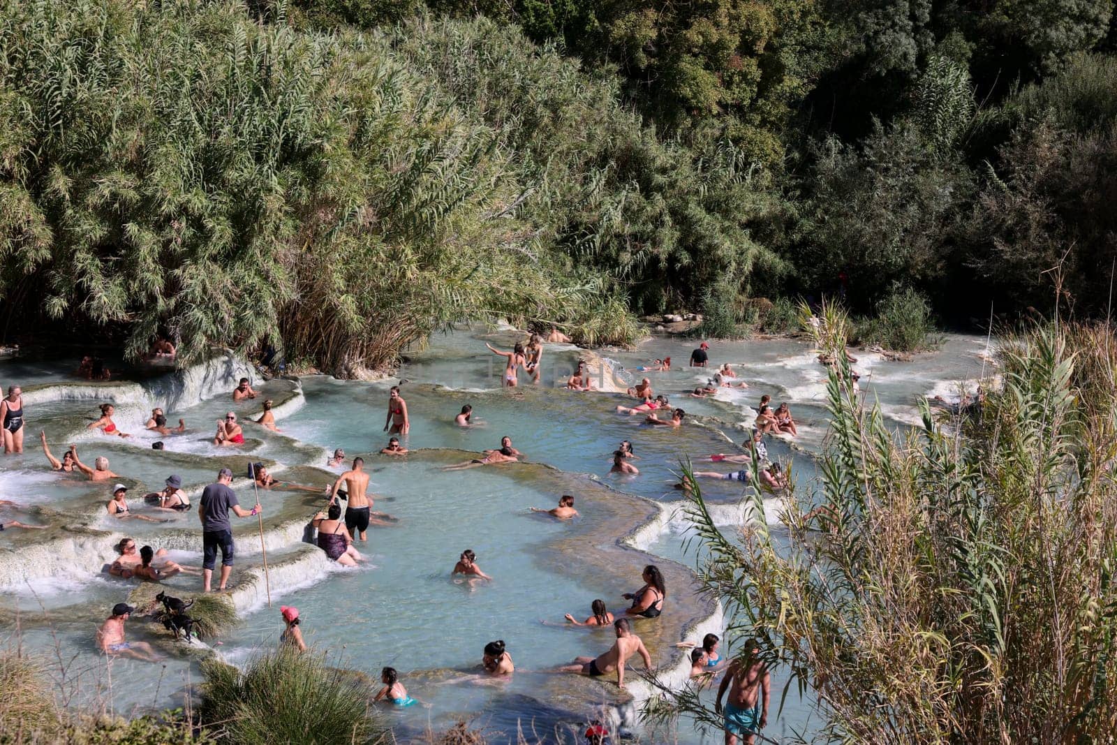 Saturnia, Italy - September 13, 2022:  People are bathing in the hot springs of Saturnia Therme, Saturnia, Tuscany, Italy