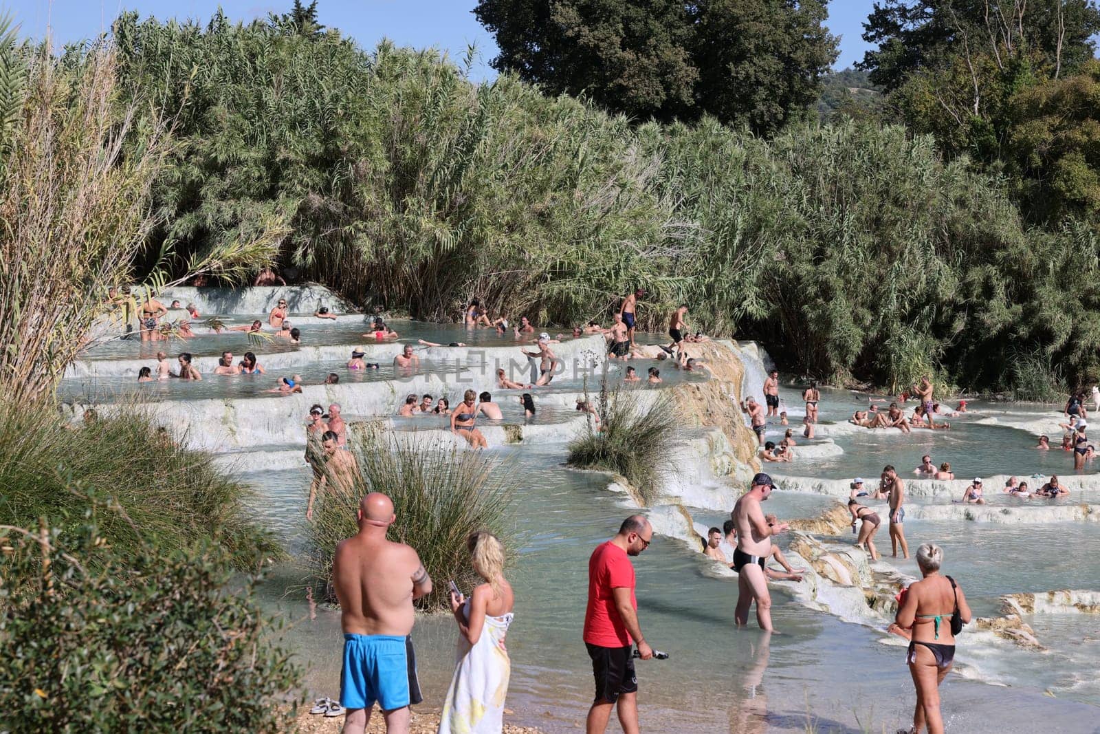 Saturnia, Italy - September 13, 2022:  People are bathing in the hot springs of Saturnia Therme, Saturnia, Tuscany, Italy