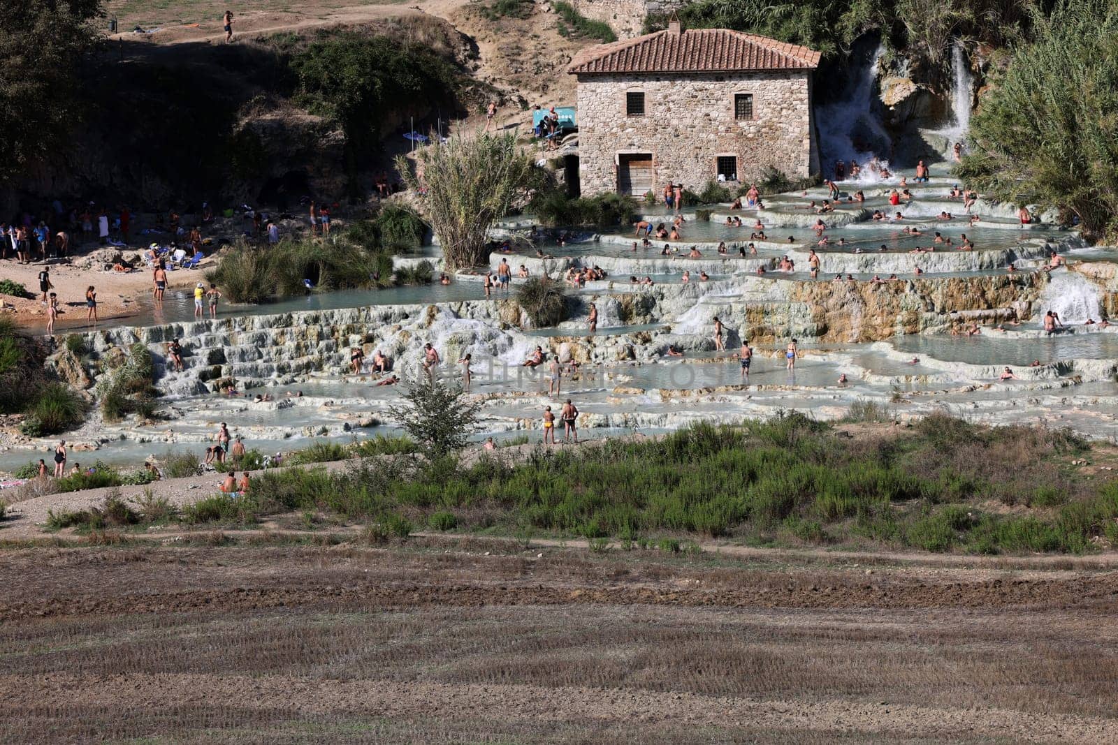Saturnia, Italy - September 13, 2022:  People are bathing in the hot springs of Saturnia Therme, Saturnia, Tuscany, Italy