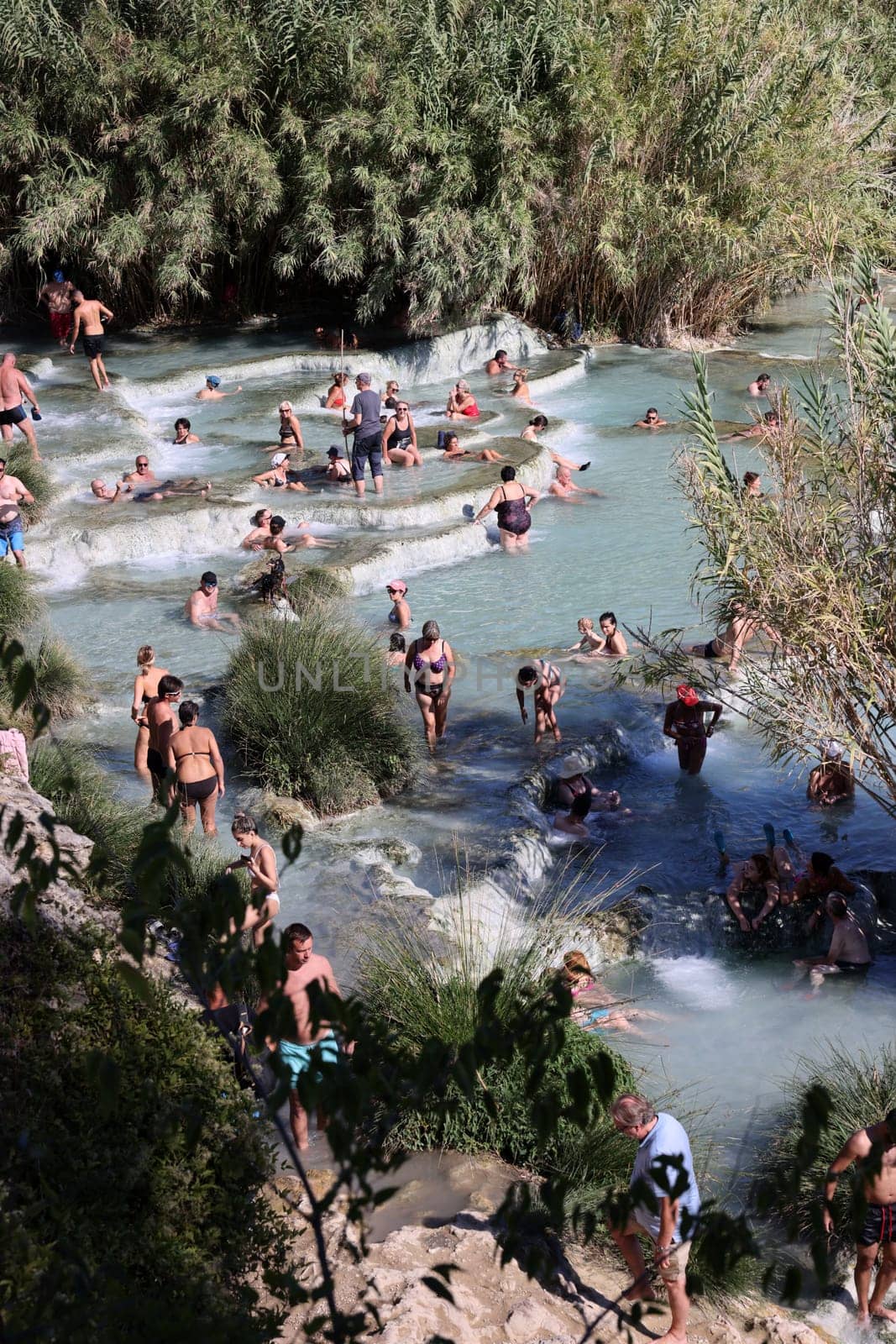 Saturnia, Italy - September 13, 2022:  People are bathing in the hot springs of Saturnia Therme, Saturnia, Tuscany, Italy