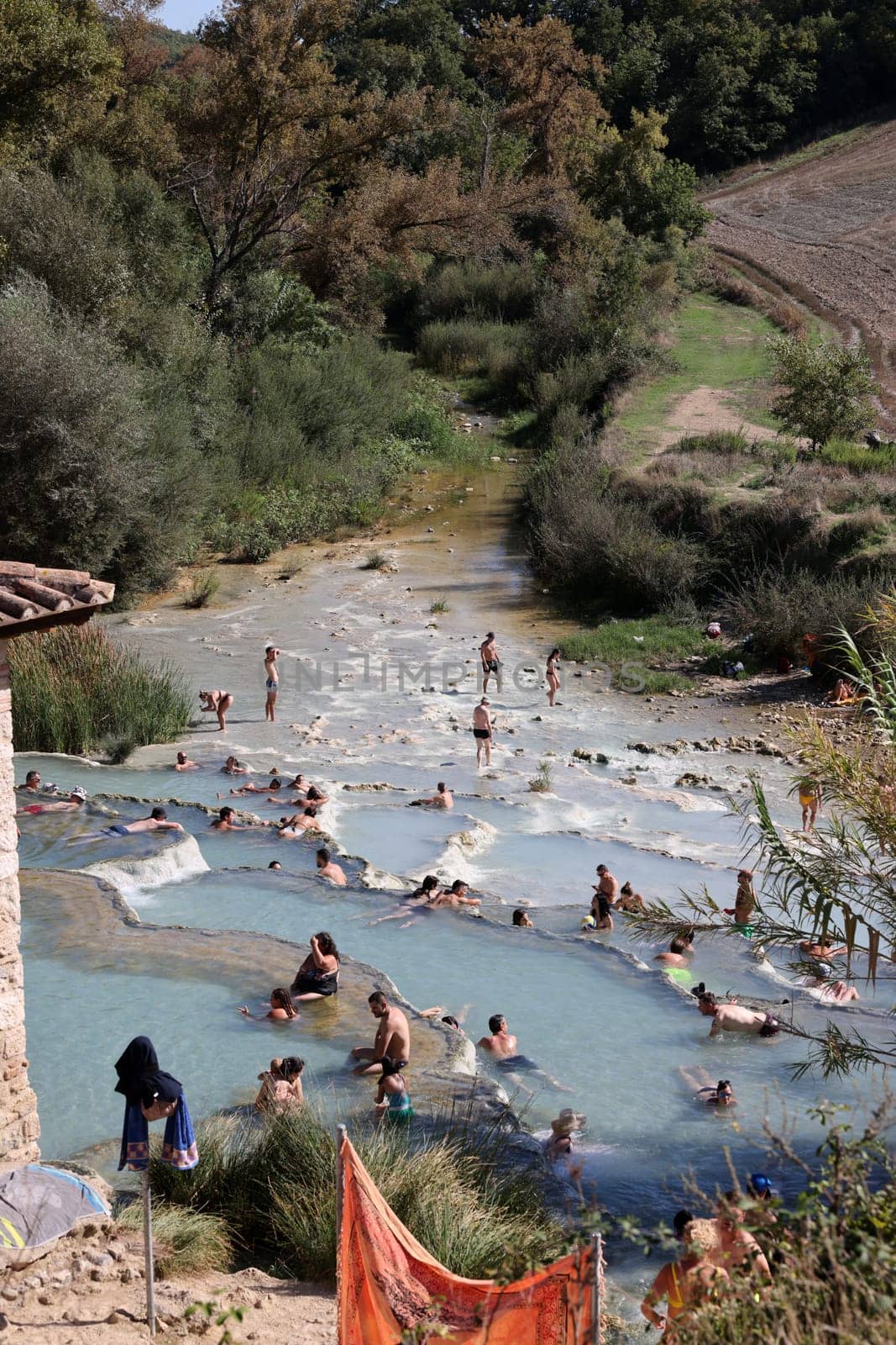 Saturnia, Italy - September 13, 2022:  People are bathing in the hot springs of Saturnia Therme, Saturnia, Tuscany, Italy