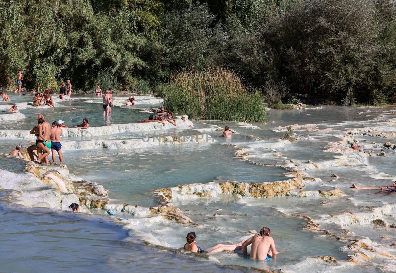 Saturnia, Italy - September 13, 2022:  People are bathing in the hot springs of Saturnia Therme, Saturnia, Tuscany, Italy