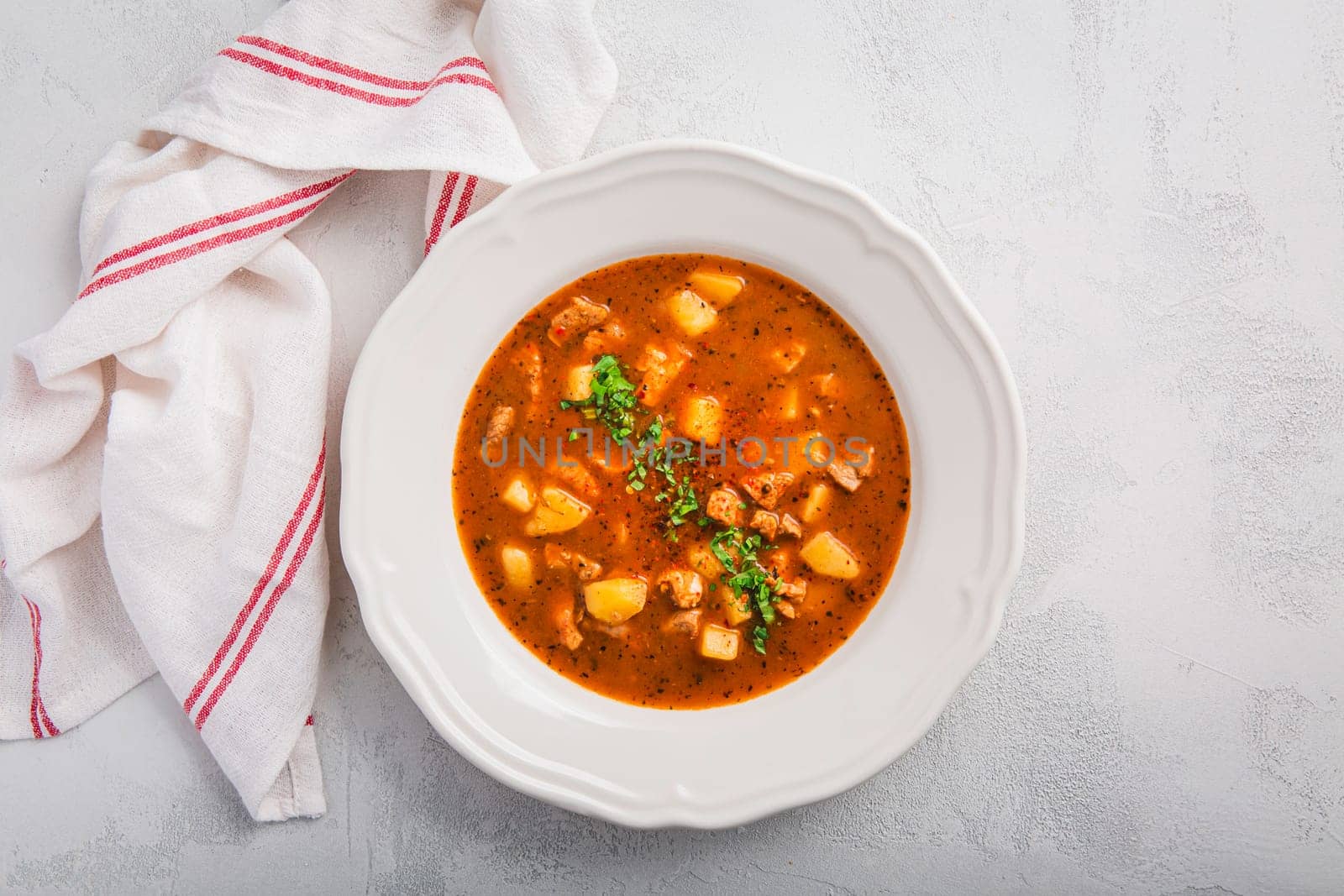 Hungarian hot goulash soup, beef, tomato, pepper, chili, smoked paprika soup. Traditional Hungarian dish.