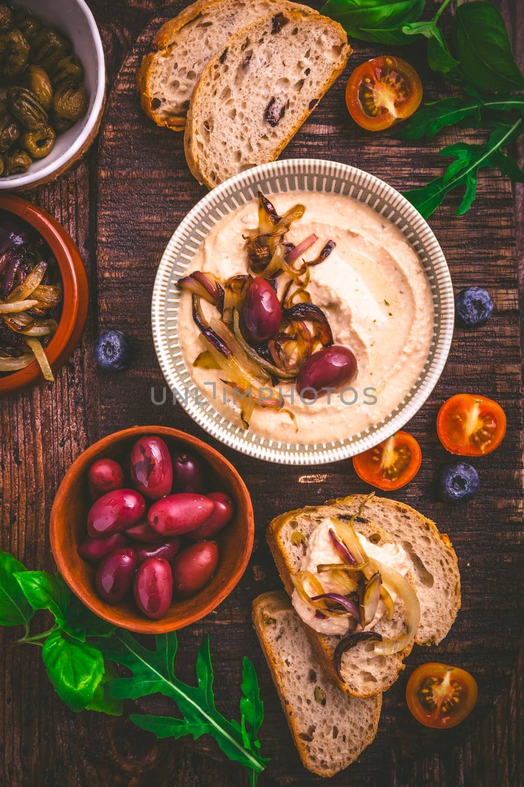 Whipped feta cheese dip with garlic, olives, lemon and caramelized onions. Greek cuisine concept, Tirokafteri dip.