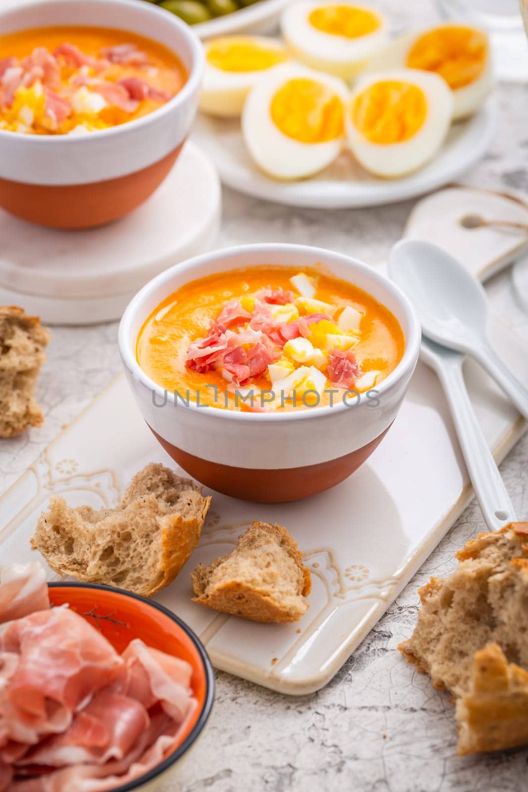 Salmorejo - raw tomato soup with ingredients on a kitchen table, spanish cuisine for hot summer