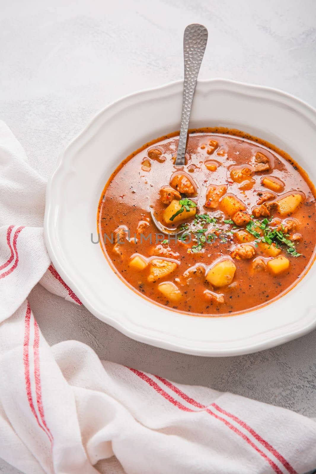 Hungarian hot goulash soup, beef, tomato, pepper, chili, smoked paprika soup. Traditional Hungarian dish.