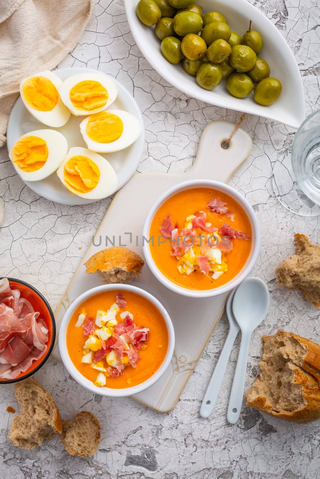 Salmorejo - raw tomato soup with ingredients on a kitchen table, spanish cuisine for hot summer