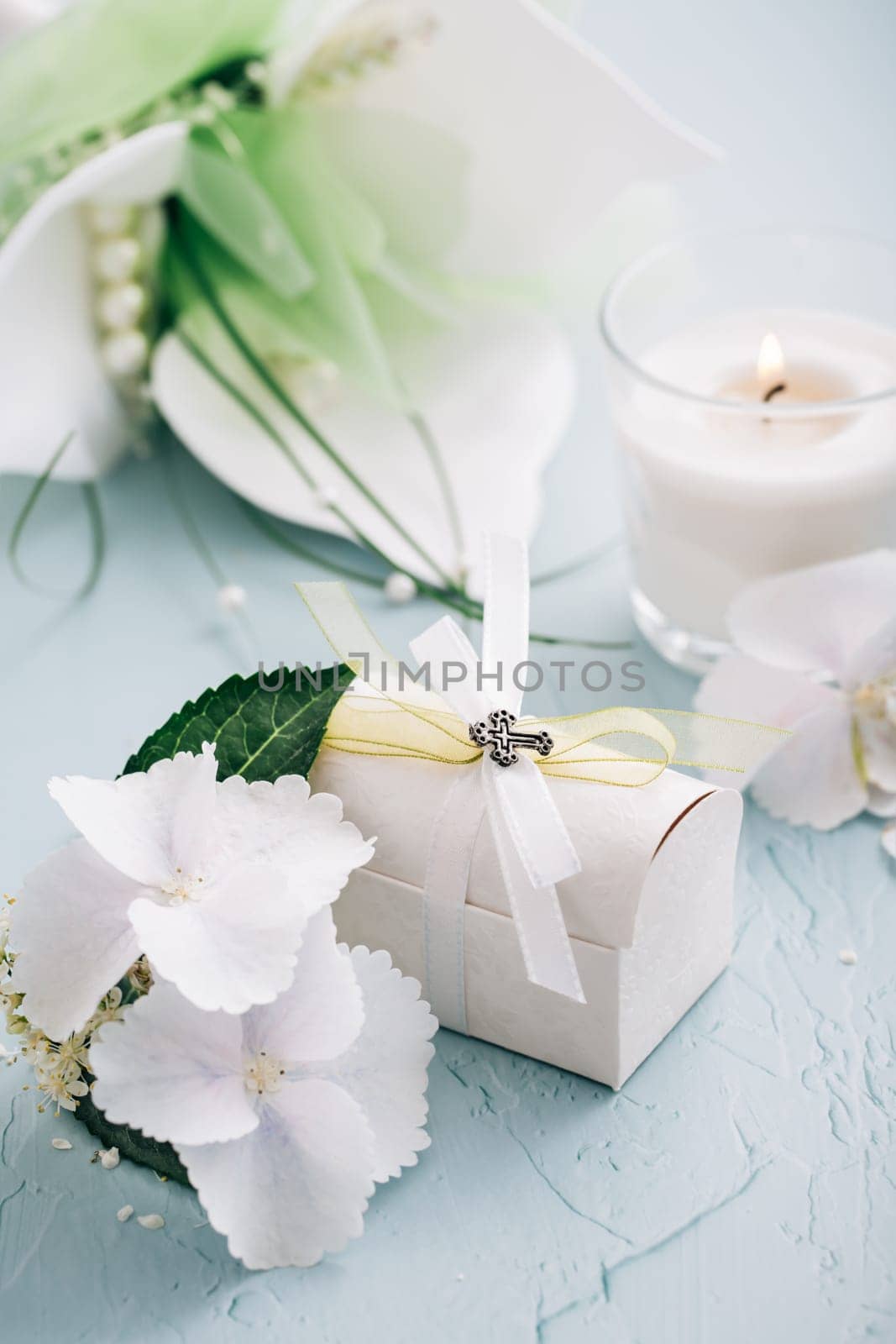Confirmation or First holy communion concept - small present with candle and flowers