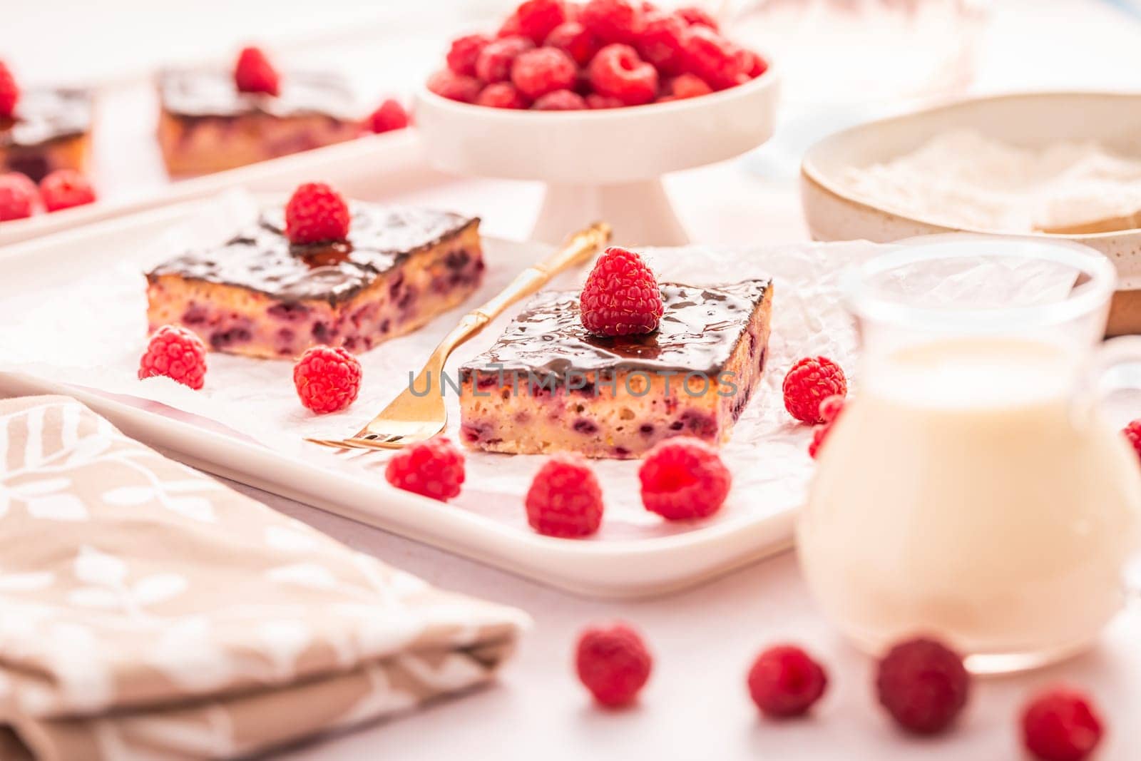 Traditional buttermilk sheet cake with raspberries and chocolate ganache