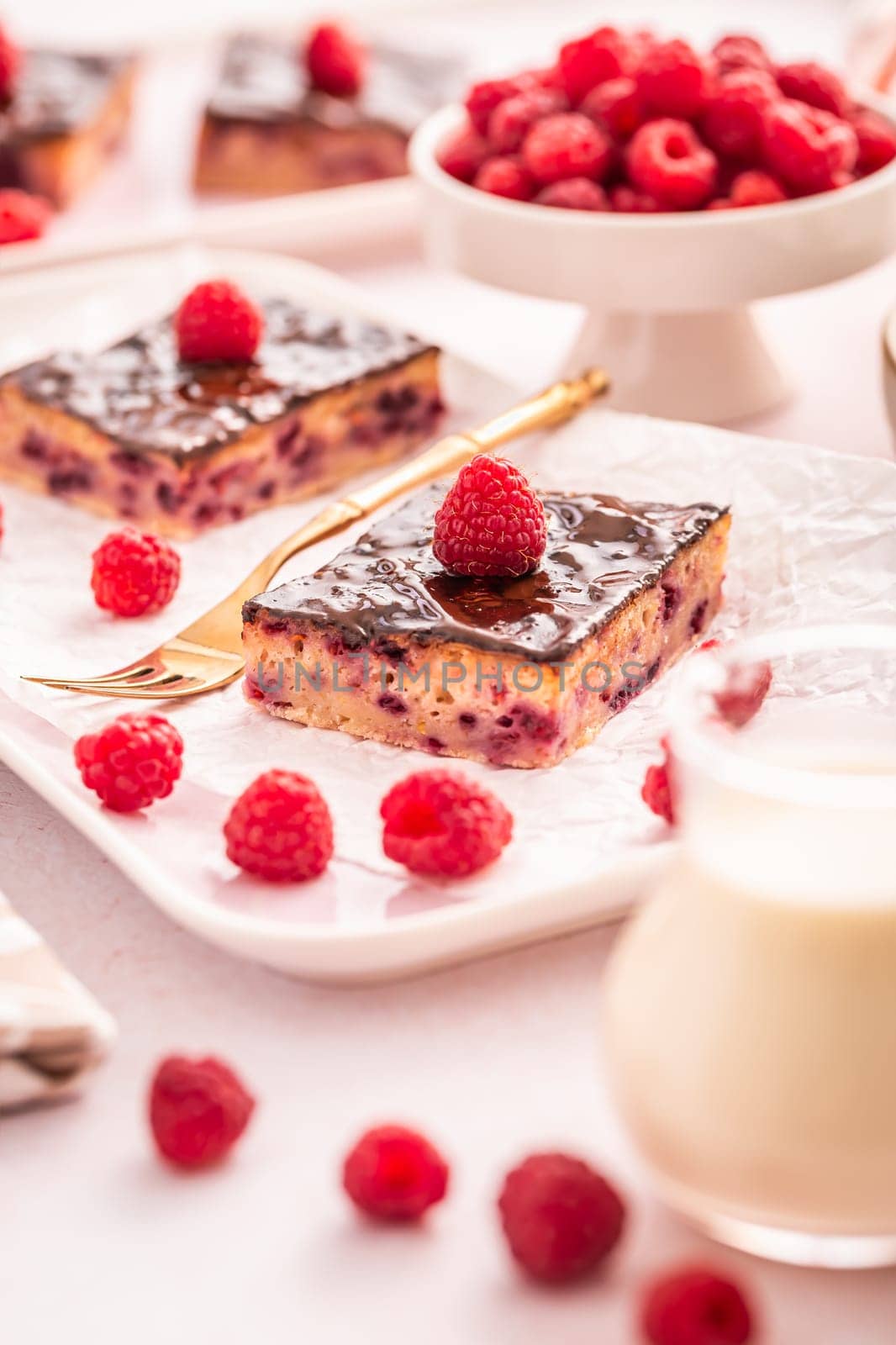 Traditional buttermilk sheet cake with raspberries and chocolate ganache