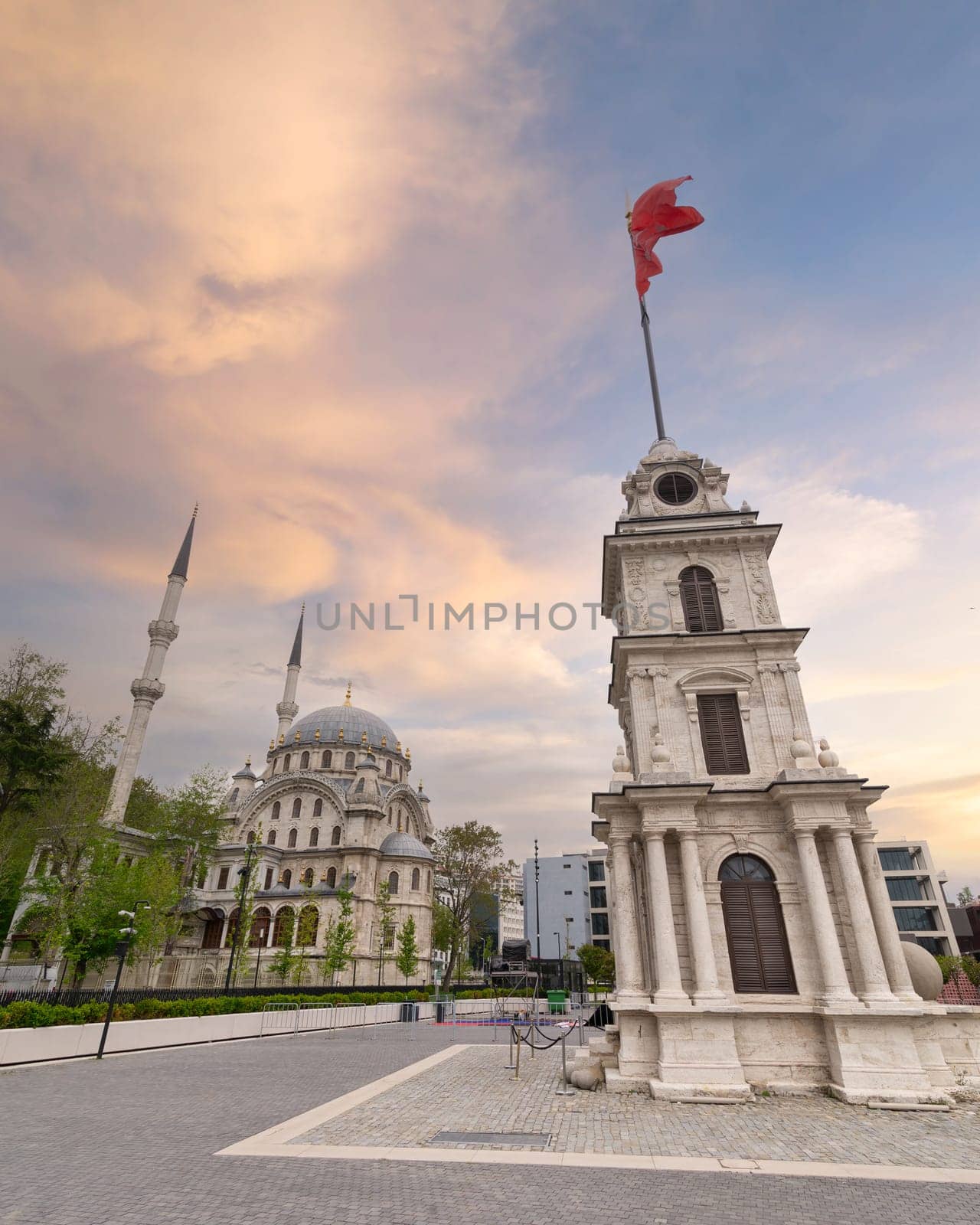 sunset of Nusretiye Clock Tower, aka Tophane Clock Tower, with Nusretiye imperial Ottoman ornate Mosque, located inside Galata Port, Tophane neighborhood, Beyoglu district, Istanbul, Turkey