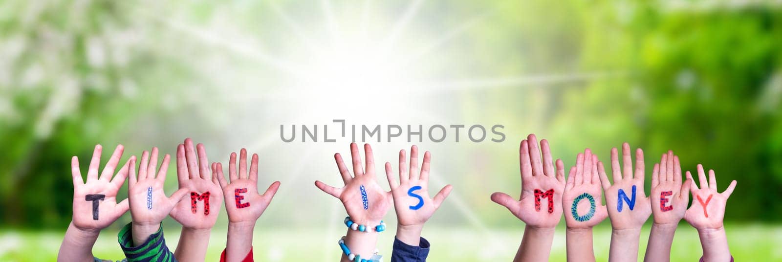 Children Hands Building Colorful English Word Time Is Money. Sunny Green Grass Meadow As Background.