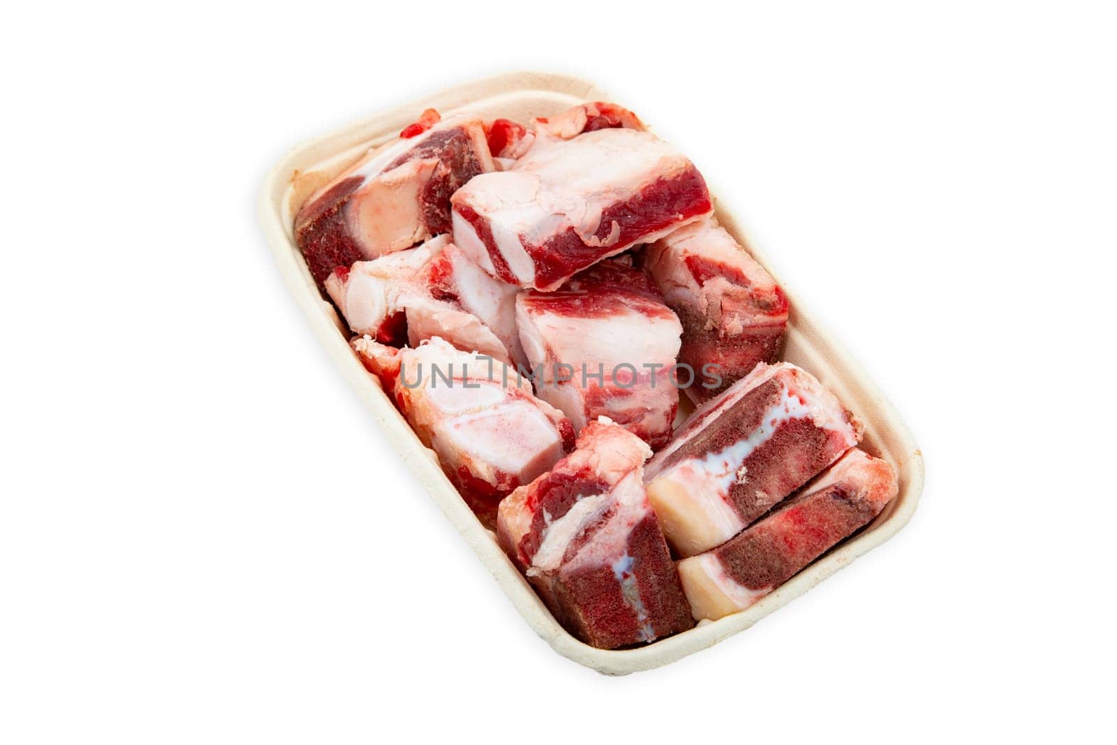 Raw beef bones for soup or sauce on a paper plate isolated over white background