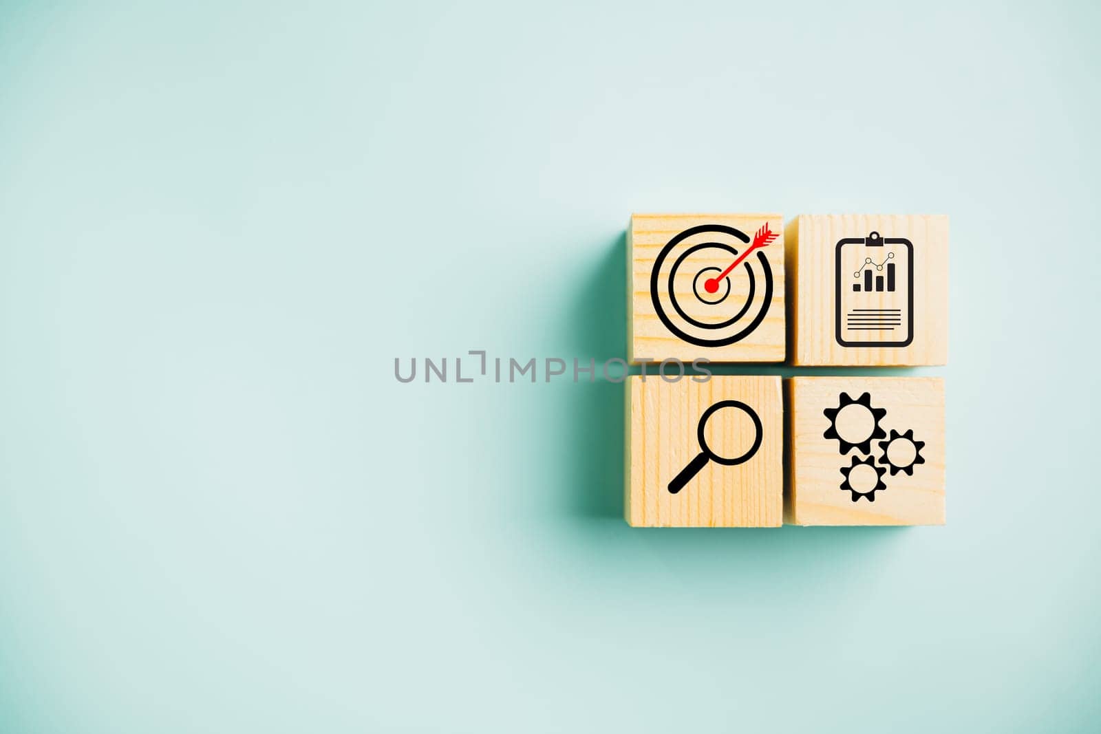 Wooden cube block step with Action Plan, Goal, and Target icons. Success and business target concept. Project management and company strategy on a blue background.