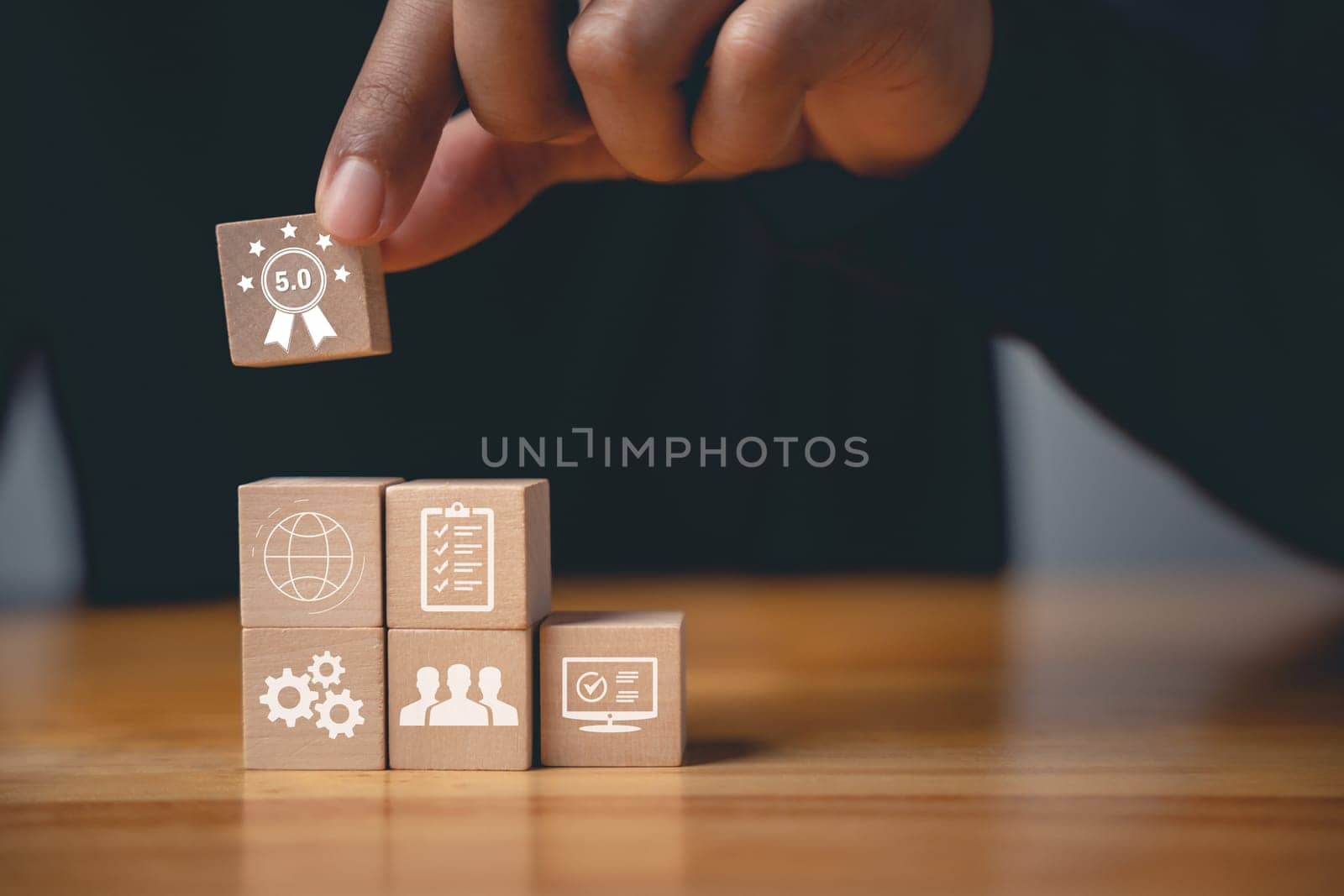 Quality control and assurance are represented by a hand placing wooden cubes with ISO icons on a table. An ISO banner in the background signifies certification and standardization
