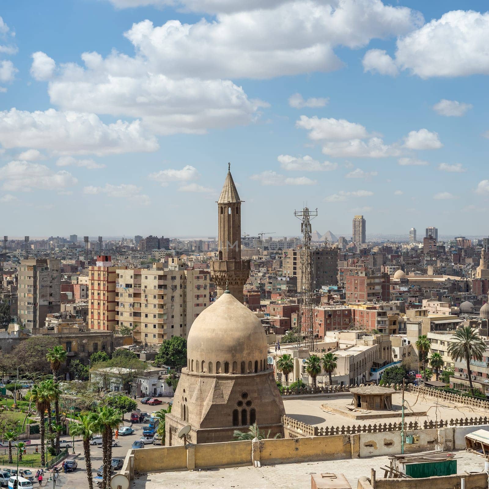Aerial day shot of dome and minaret of Ottoman era Masjed Almahmodyah - Mosque of Almahmodyah in cloudy day, located in Cairo Citadel square, Old Cairo, Egypt