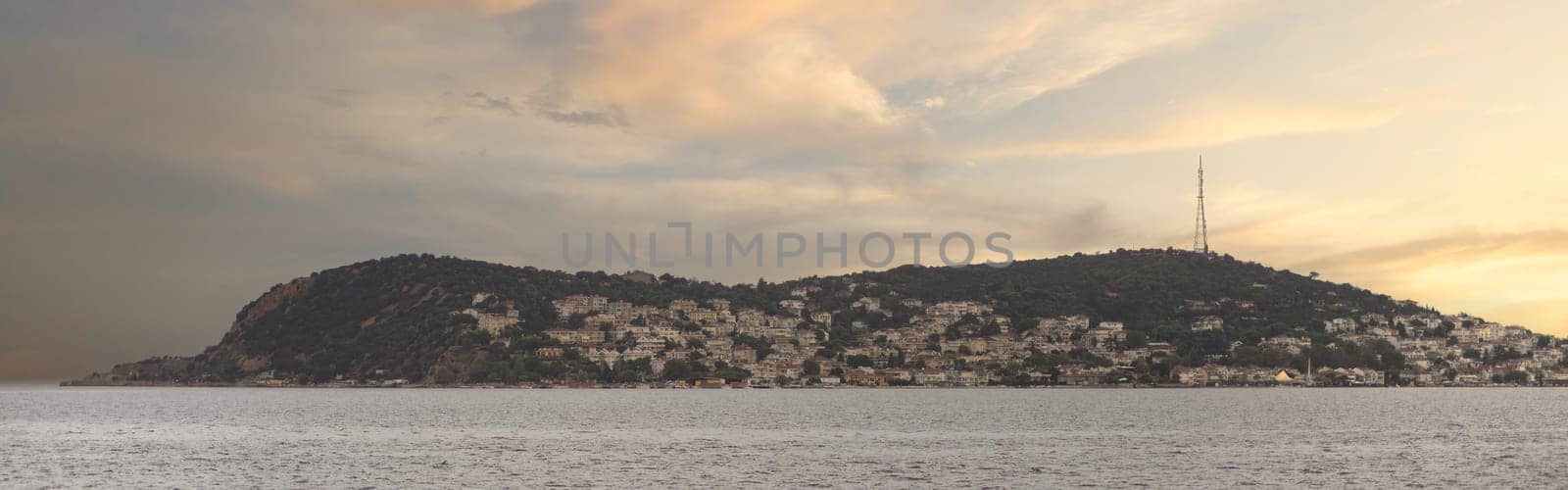 View of the mountains of Kinaliada island from Marmara Sea, with traditional summer houses and boats, Istanbul, Turkey