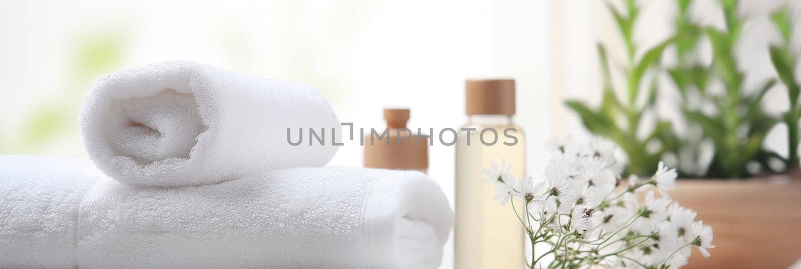 Toiletries, soap, towel on blurred white bathroom spa background.