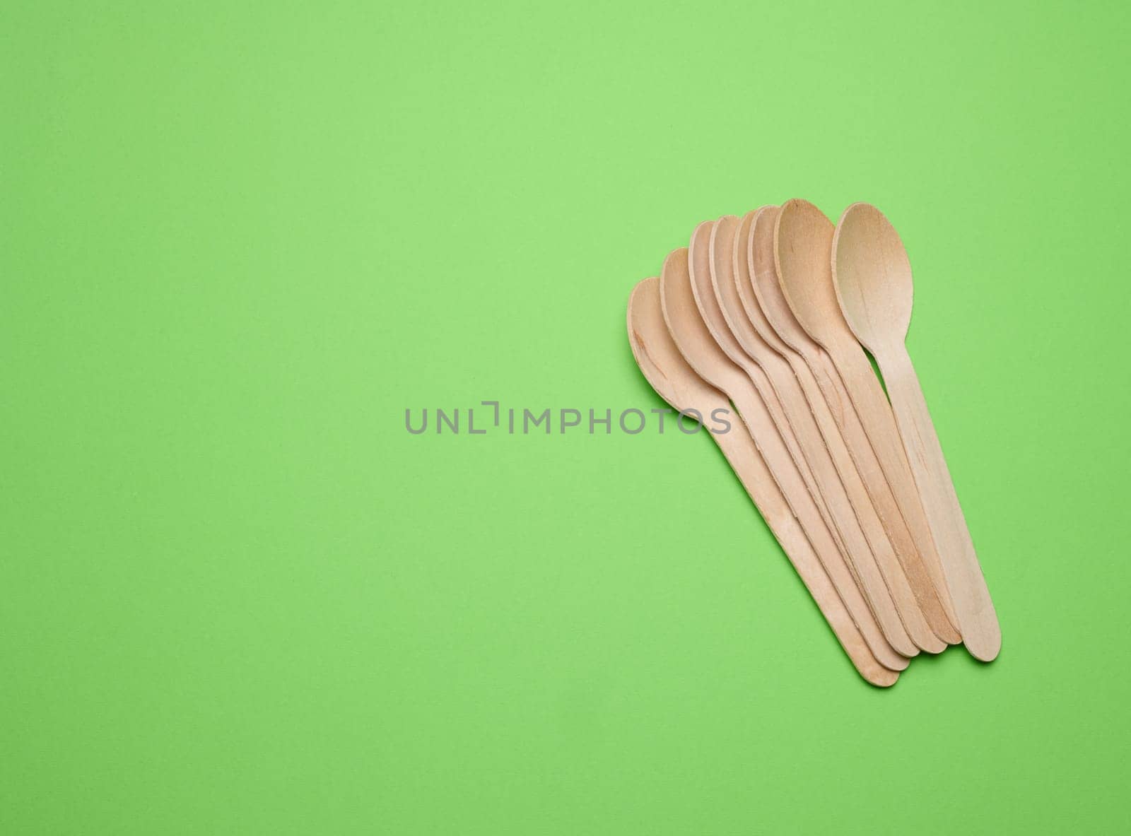 New wooden spoon, top view. Recycling materials