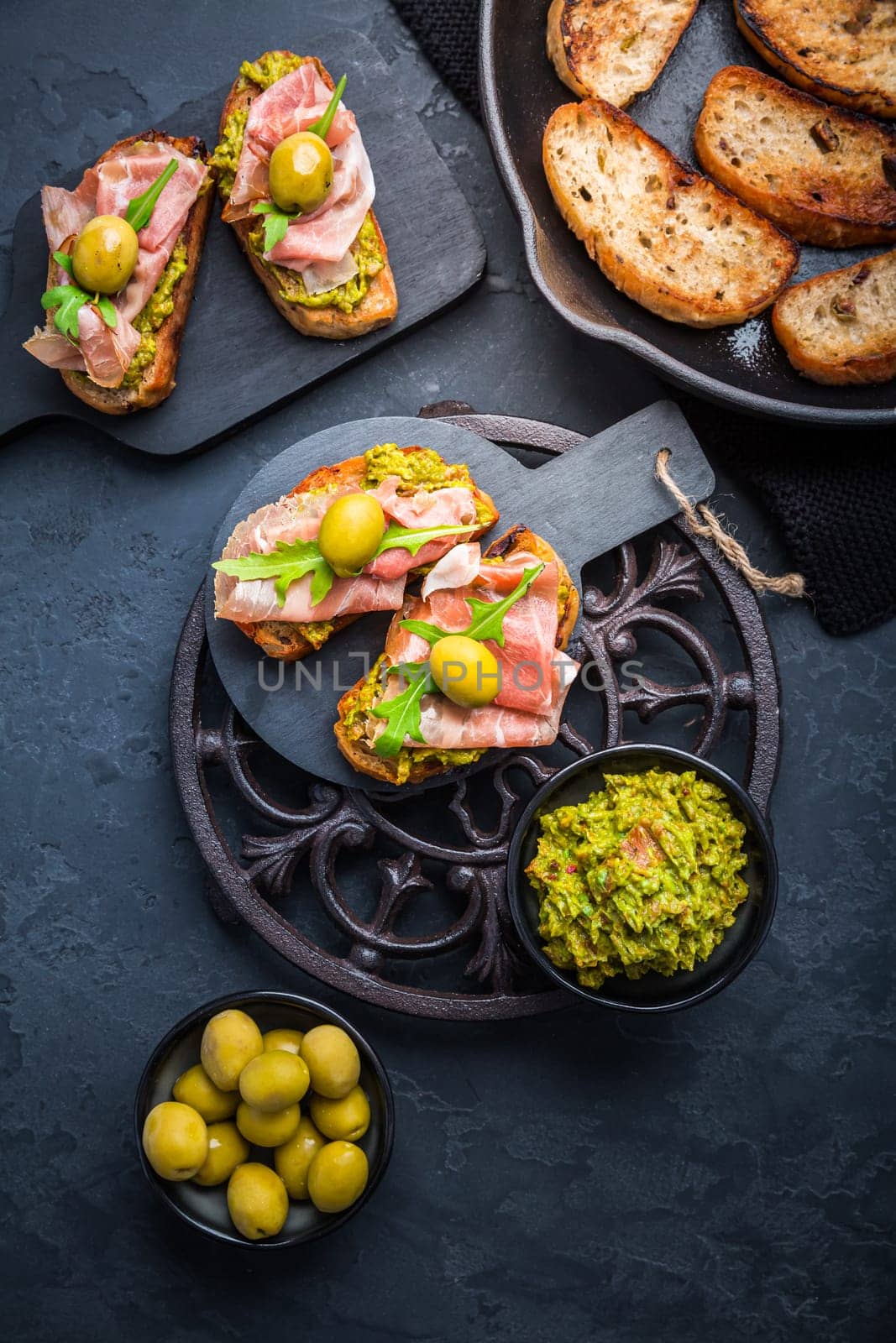 Delicious crostini with avocado spread and serrano or prosciutto ham
