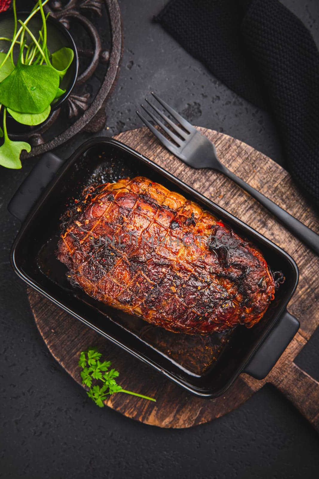 Roasted turkey breast in casserole on black background