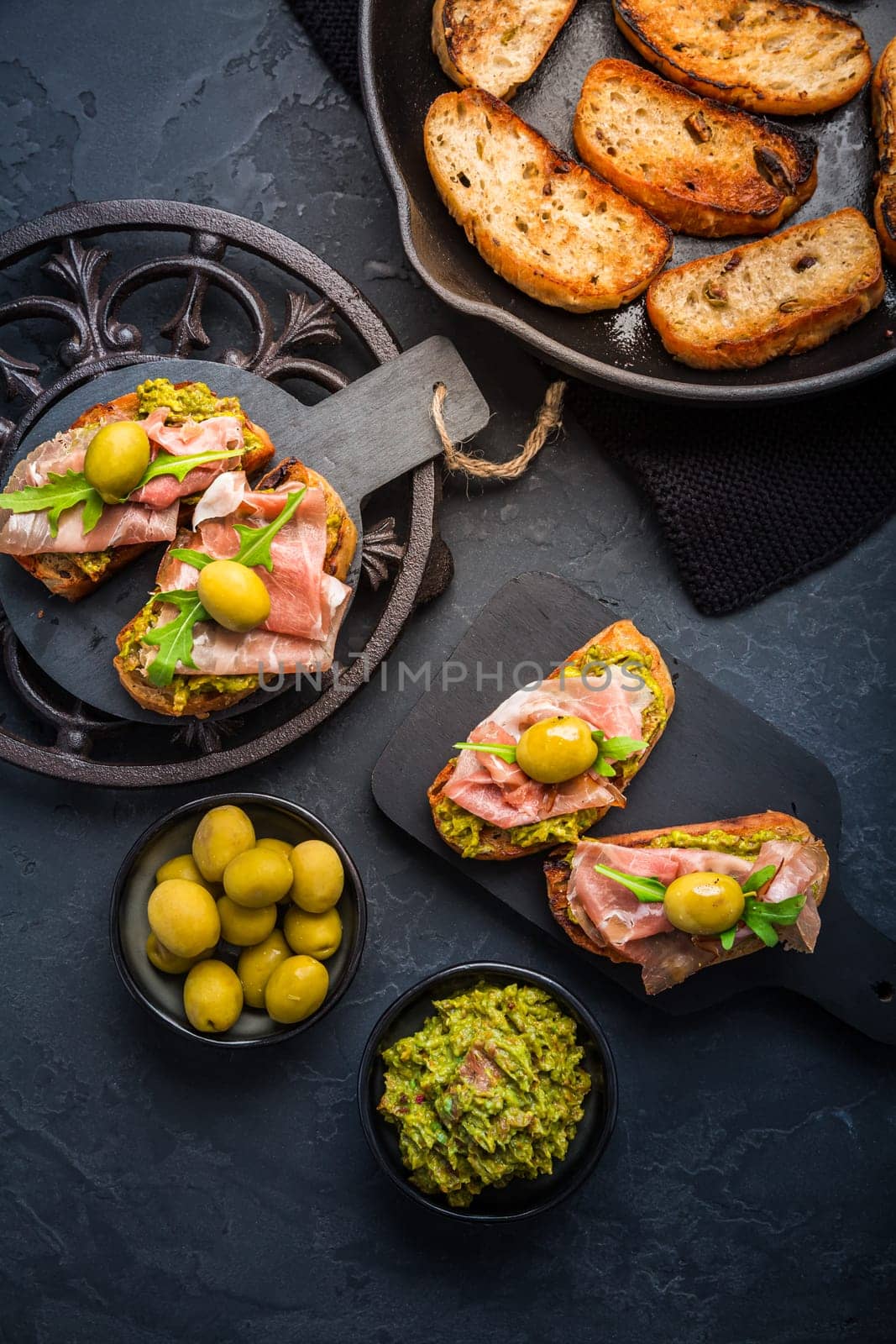 Delicious crostini with avocado spread and serrano or prosciutto ham