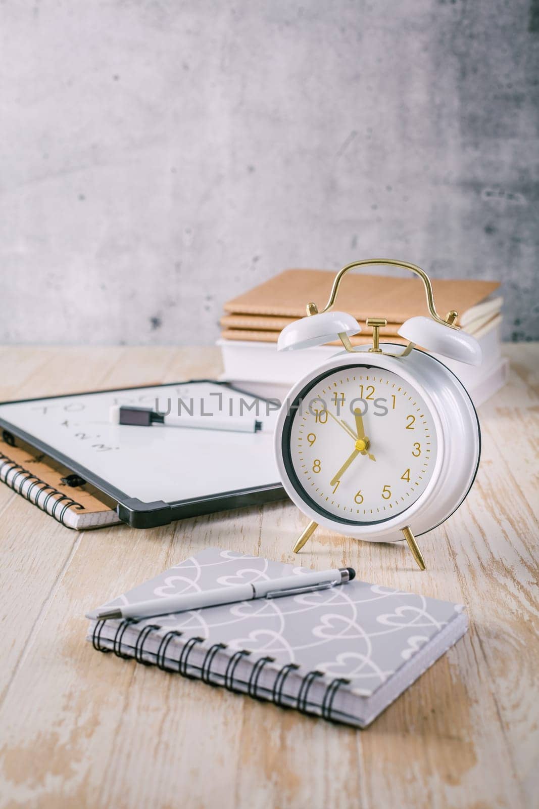 Alarm clock and books - time management and procrastination concept