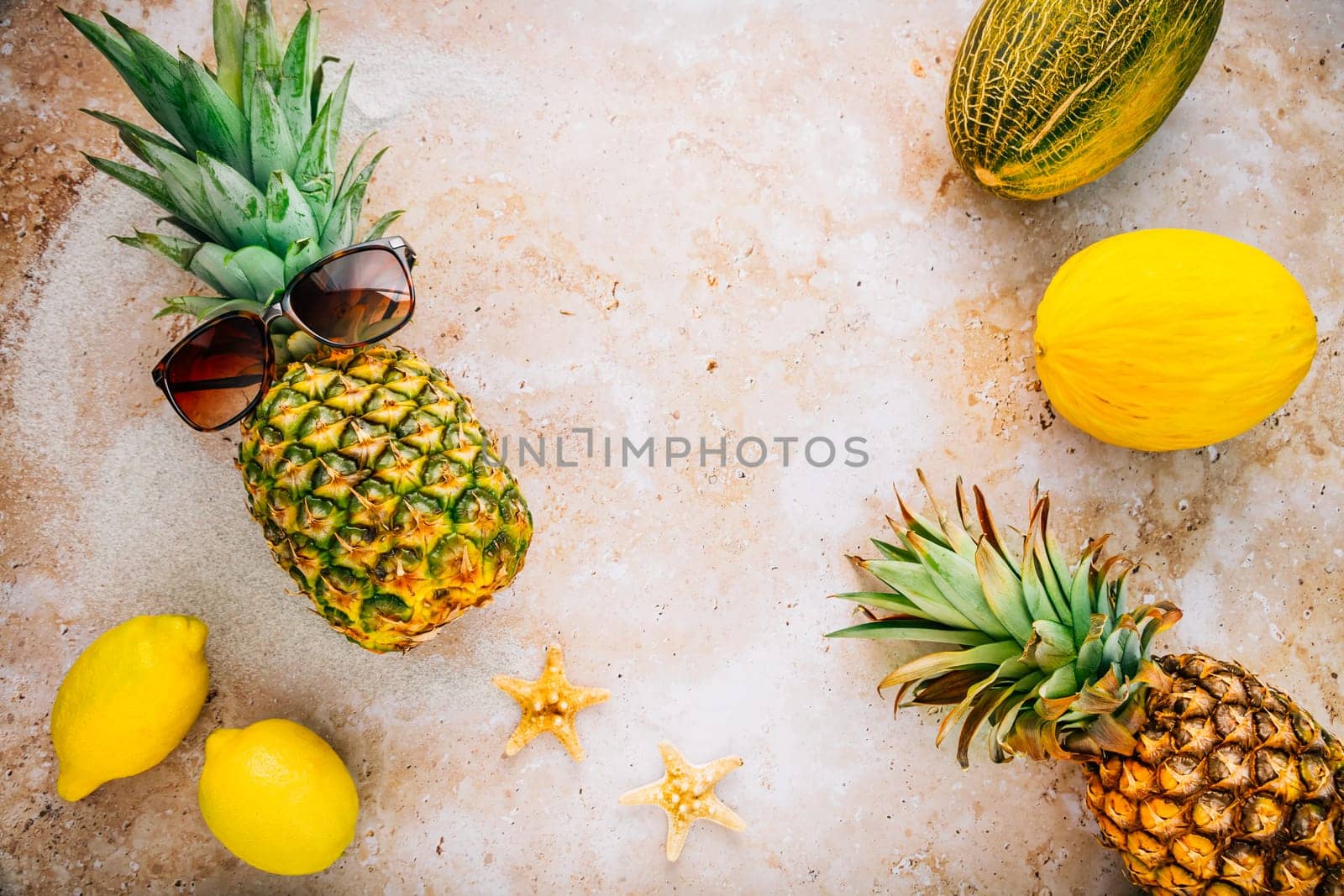 Summer concept - Pineapple hipster in sunglasses with melon and lemons, creative art fashionable vacation concept
