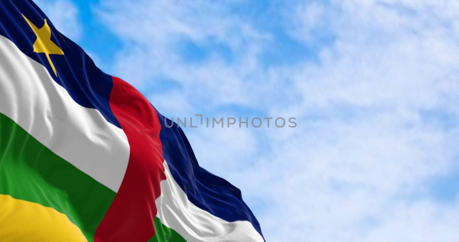 National flag of Central African Republic waving on a clear day. Blue, white, green, and yellow stripes with a red stripe in the middle and a yellow star in the canton. 3d illustration render. Fluttering fabric