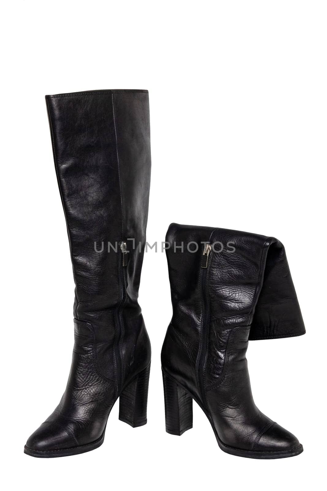 A pair of black elegant female boots or woman shoes isolated on a white background. Leather boots.