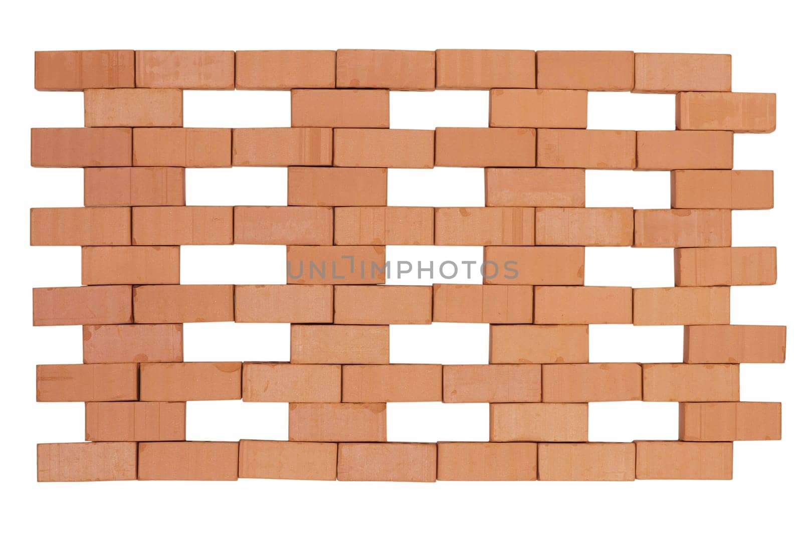 Frontal view of a brick wall with regularly omitted single bricks isolated on white.