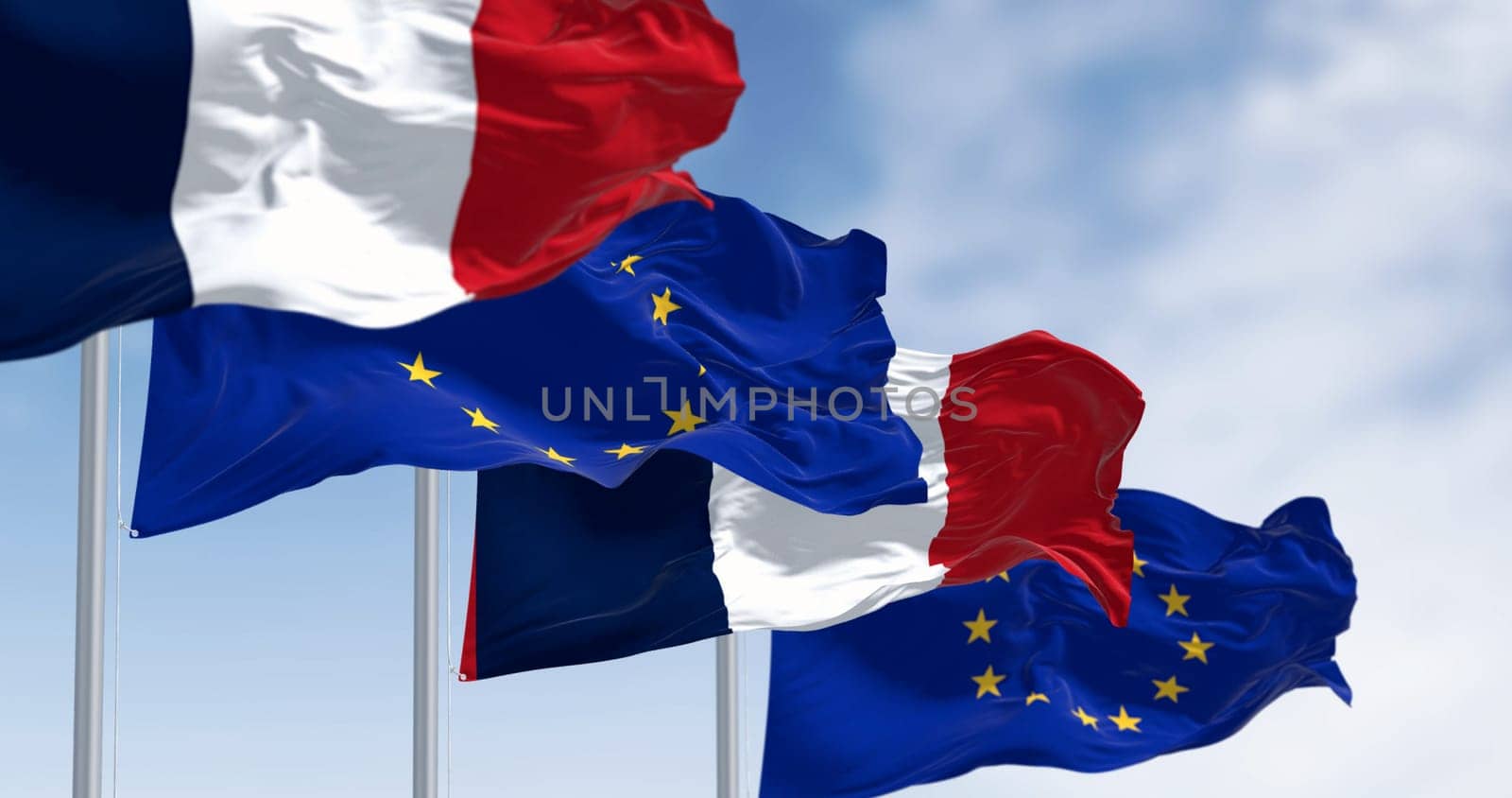 Flags of France and the European Union waving together on a clear day. France became a member of the European Union on January 1, 1958. 3d illustration render. Selective focus. Fluttering fabric