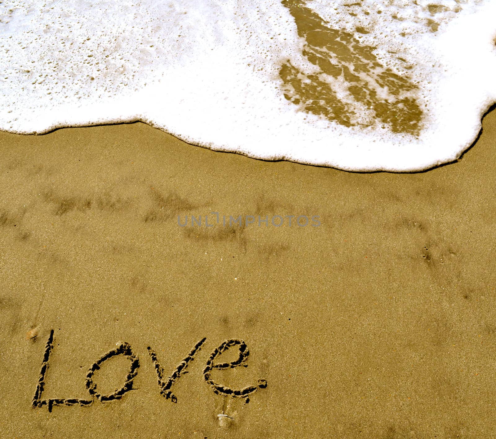 Love written in the sand with wave 11