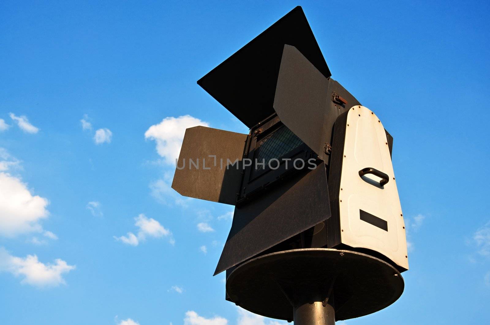 Architectural searchlight on a background of a blue sky.