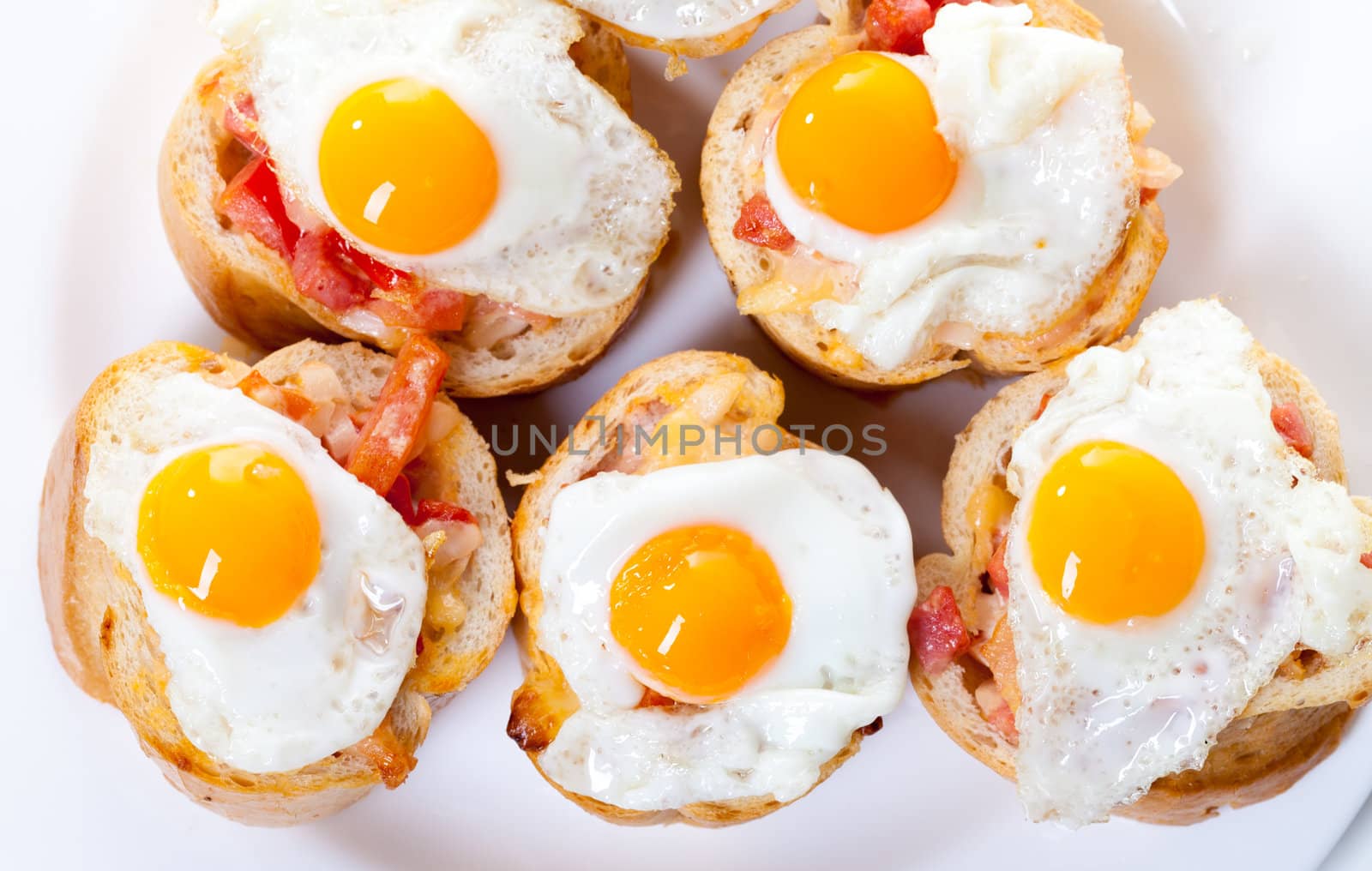 Baguette Slice with Ham and Fried Quail Egg, closeup